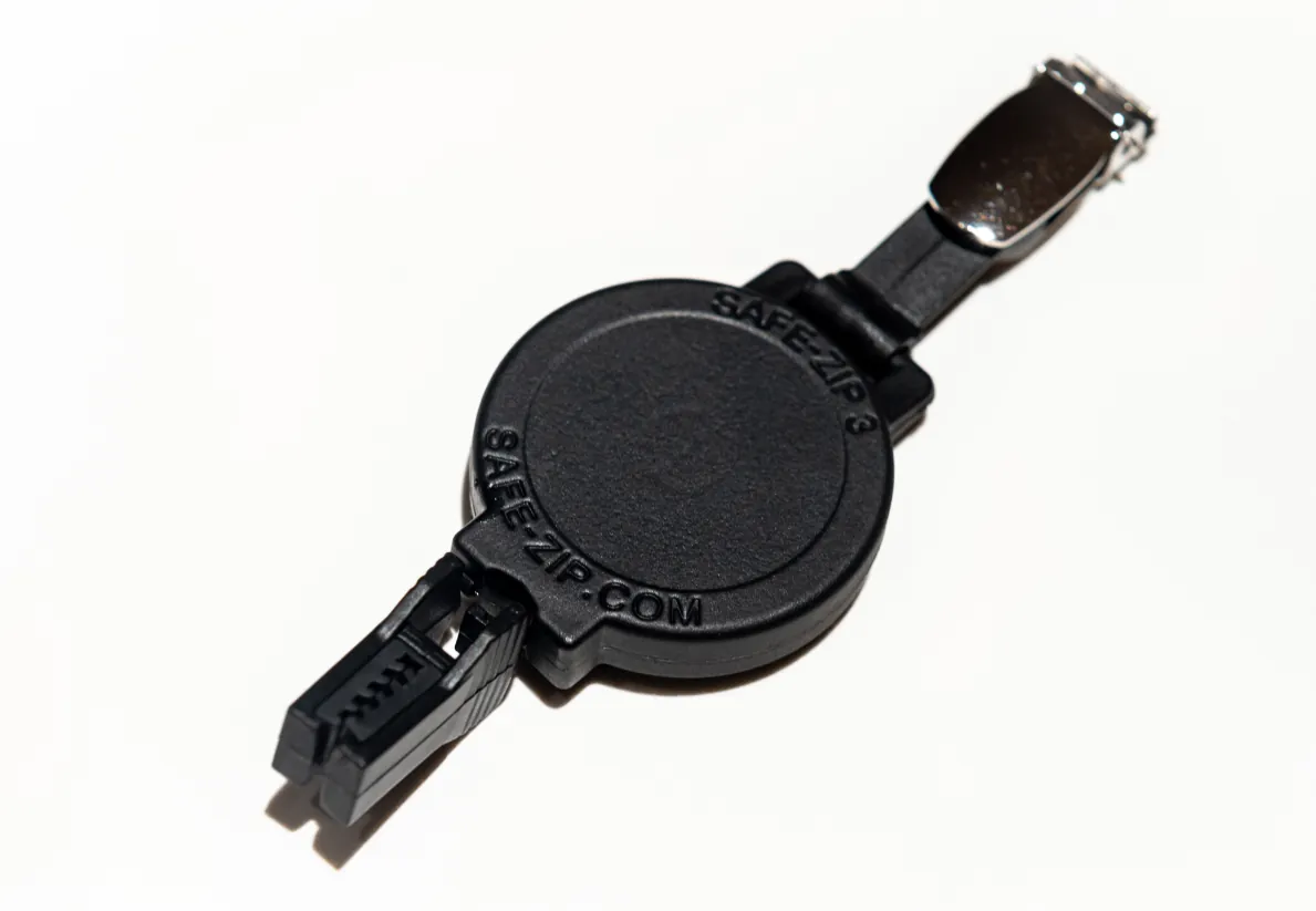 Badge reel with belt clip and friction clamp